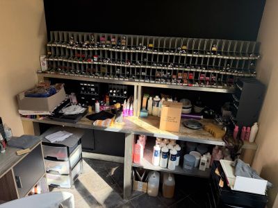 many bottles of nail polish on the shelves in the room