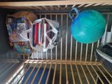 a blue ball sitting on top of a shelf next to a blue ball