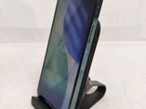 a close up of a phone on a stand on a table