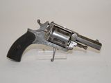 an old revolver with a wooden handle on a white surface