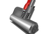 a close up of a vacuum with a red handle on a white background