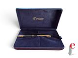 a box with a pen inside of it on a white surface