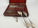 silverware in a wooden case with spoons and spoons in it