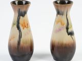 two vases sitting side by side on a white surface