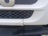 a close up of the front bumper of a white truck