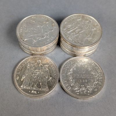 four silver coins sitting on top of each other on top of a table