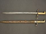 two swords with gold and silver on a black background