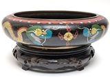 a black bowl with a dragon design on it