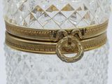 a glass jar with a gold ring on top of it