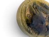 an image of a ceramic object with a bird on it