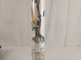 a glass vase with a drawing of a dragon on it