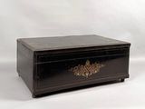 a black box with gold decorations on it on a white background
