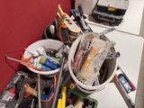 a bucket full of tools sitting on a table