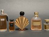 several different types of perfume bottles lined up on a table