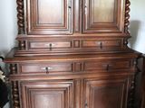 a large wooden cabinet with a bowl on top of it