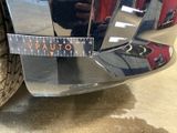 a close up of a car ' s rear bumper with a measuring tape on it