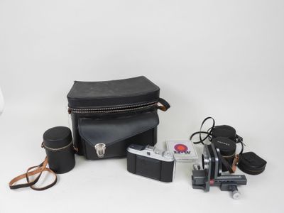 a camera, a camera case, a camera and other items on a white surface
