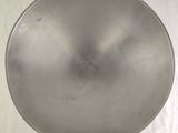 a large metal pan sitting on a white surface