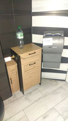 a toilet and a trash can in a small room