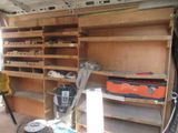 a garage with a lot of shelves and tools in it