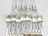 a lot of silver spoons and forks on the table