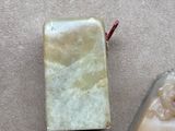 two pieces of soap sitting on a table next to each other