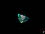 a close up of a green and white diamond on a black background
