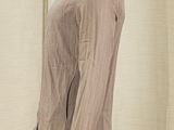 brown jacket on a mannequin mannequin in front of a beige curtain