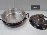 a silver pot with a lid sitting on a table