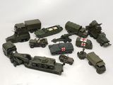 a lot of toy army vehicles on a white surface