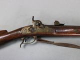 a close up of a rifle on a table with a white background
