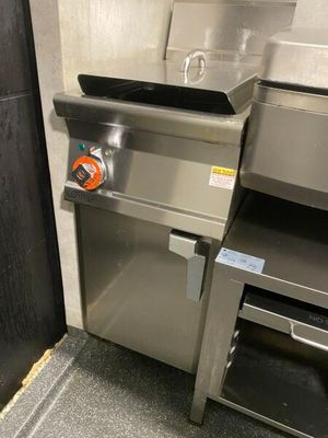 a stainless steel sink in a kitchen with a black door