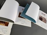 three open books on a table with pictures of people in the pages