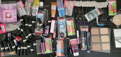 a lot of makeup and makeup products laid out on a table
