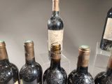 several bottles of wine are lined up in a row on a table
