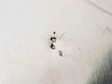 a close up of a silver plate with a black and white design
