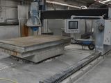 a large machine that is cutting a piece of wood in a building