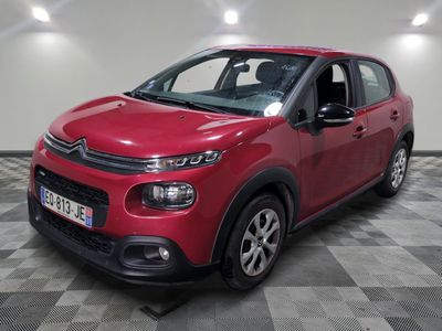 a red citrole is parked on a checkered floor