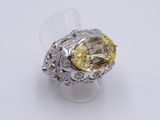 an image of a yellow and white diamond ring on a white surface