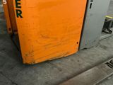 a large orange machine that is sitting in the garage