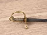 an image of a sword with a handle on a wooden table