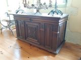 une grande armoire en bois dans une pièce où il y a un miroir accroché au mur