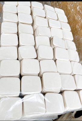 a pile of white containers sitting on top of a table
