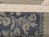 a cat that is sitting on a rug on the floor