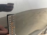 someone is measuring the height of a car with a ruler