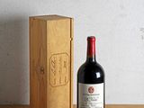 a bottle of wine sitting next to a box on a table