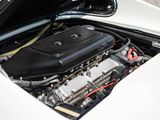 the engine compartment of a white sports car with its hood open