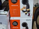 three boxes of coffee machines on the shelf in the store