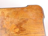 a close up of a wooden table with a flower on it