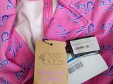 a pink jacket with a tag on it and a tag attached to it